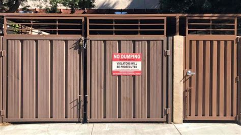 trash enclosure with swingable gate